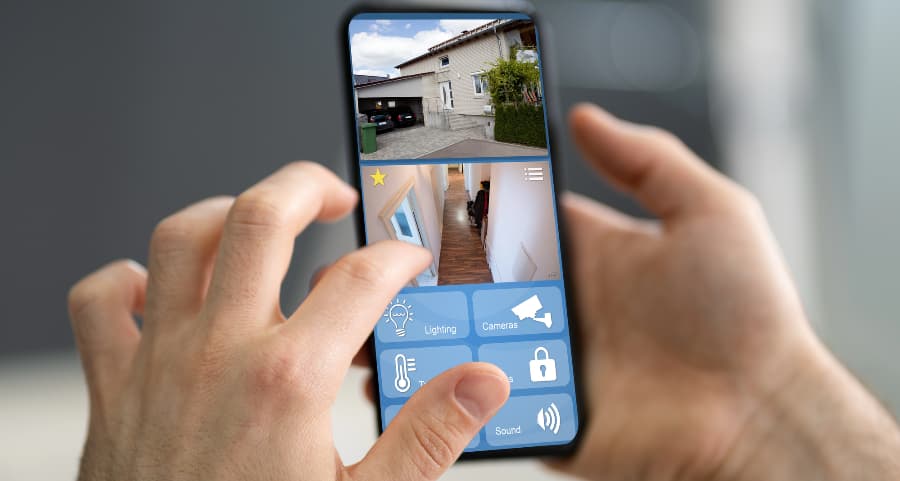 Homeowner examining surveillance camera streams on a smartphone